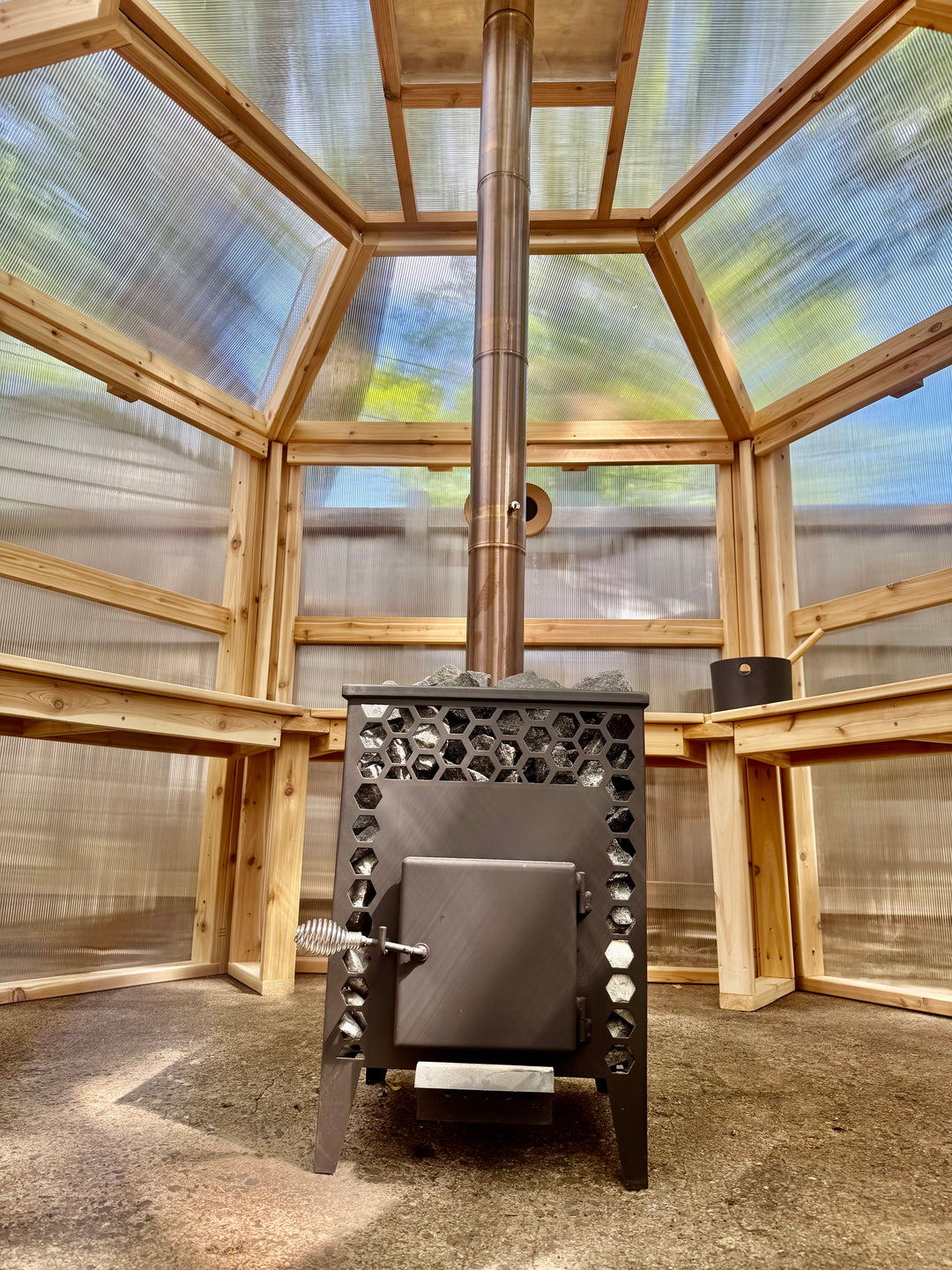 Interior view of Nippa stove and translucent panels inside NorthUp Hex sauna