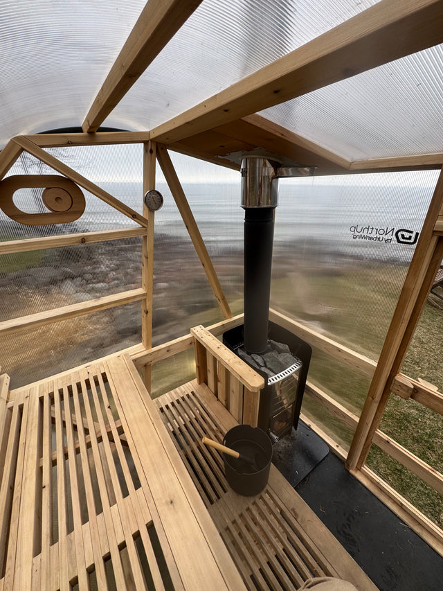 Interior view of a NorthUp Curve. Lake visible through transparent panels.