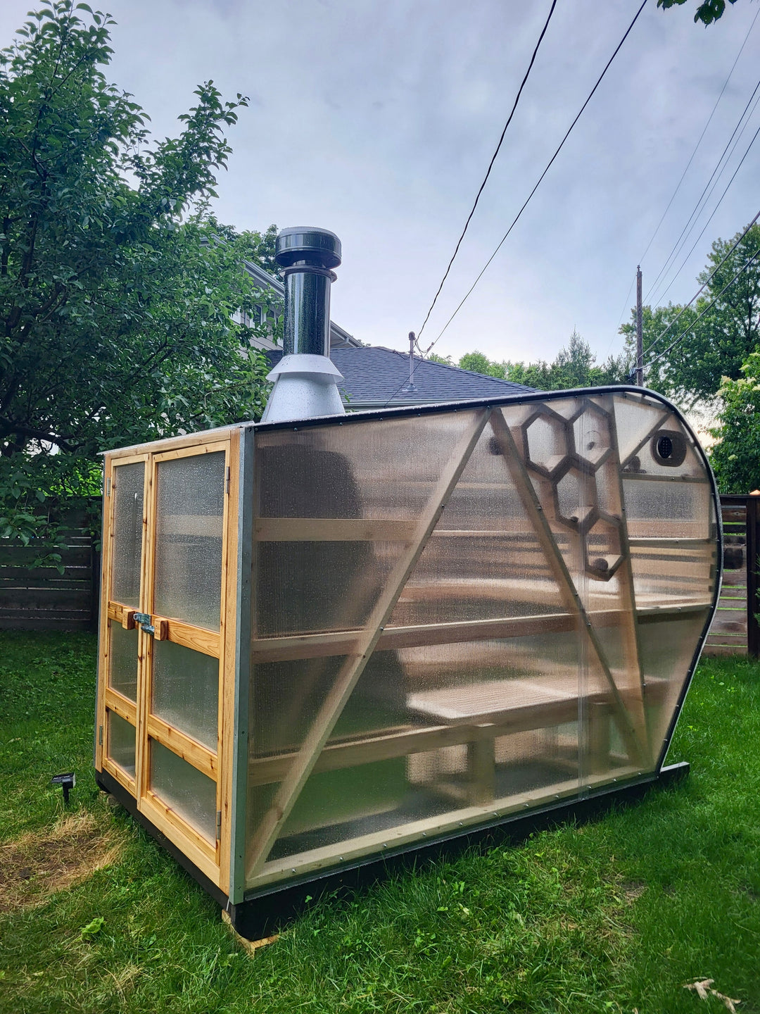 NorthUp Curve XL parked in backyard on green grass during the rain.