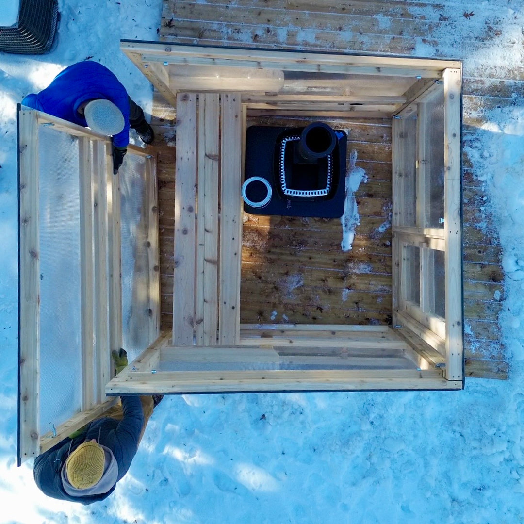2 people installing a sauna kit modular wall